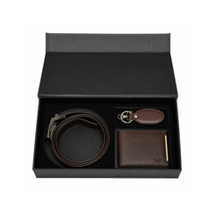 A men's leather gift set in an open black presentation box, featuring a dark brown belt with a silver buckle, a dark brown bifold wallet with gold-tone hardware, and a matching leather keychain.